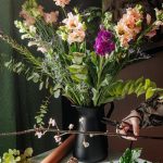 white and purple flowers in black vase